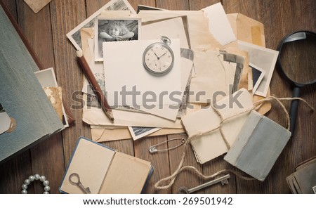 old photos and letters on the wooden table