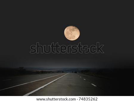 Highway passing through desert in moon light