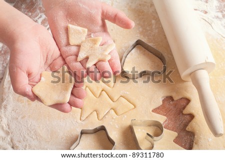 little girl cutting christmas gingerbread cookies, hands only