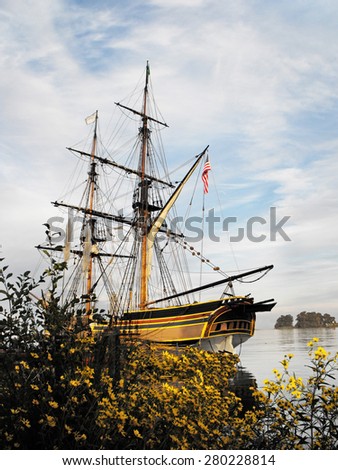 Photograph of a Pirate Ship with an USA flag is sailing home on a beautiful day.