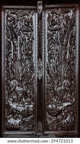 black dark thai god painting carving wood door in temple