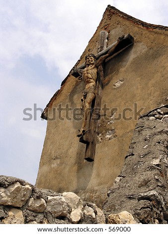 Jesus on the cross with a wall in the foreground