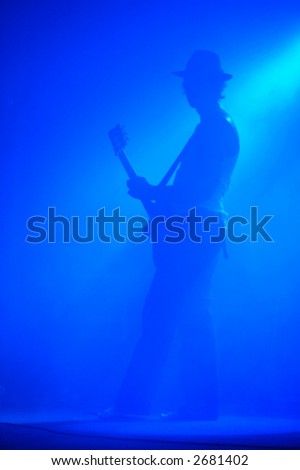 Guitarist shrouded in blue light