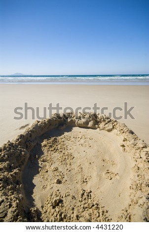 Remains of sandcastle on beach.