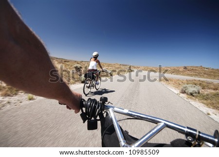 Cyclist view of riding bike down desert road