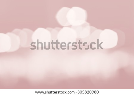 Beautiful black and white blurred lights on a light pink background