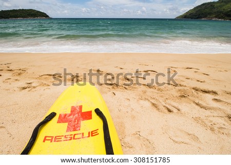 The yellow surf rescue board ready on the beach.
