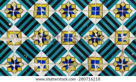 Old Portuguese glazed tiles form pretty a geometric pattern.