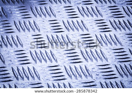 Blue colored Diamond plate also known as checker plate, tread plate, cross hatch kick plate and Durbar floor plate, closeup with deep depth of focus in landscape orientation..