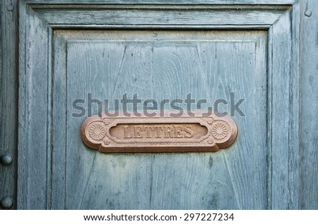 Old french letter box on blue wood door