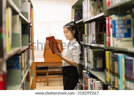 woman asia student read a book in Library