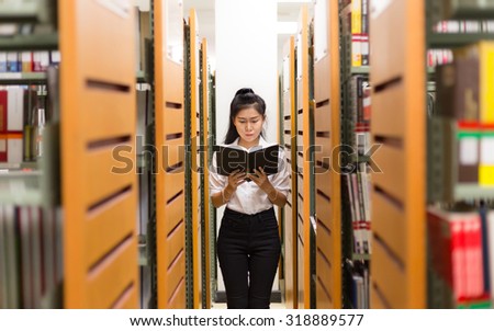 woman asia student reading a book in Library