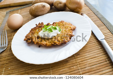 potato pancake with sour cream and parsley