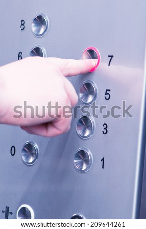 white man pushing buttons on an elevator