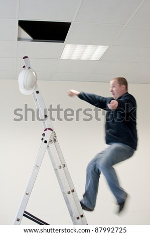 a young man falls from ladder