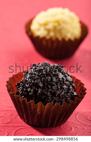 Organic chocolate truffle ball on red background