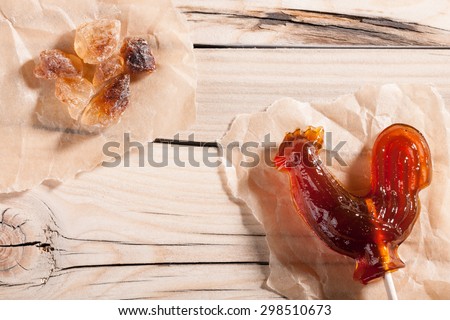 Candy and rock sugar on wooden background close-up