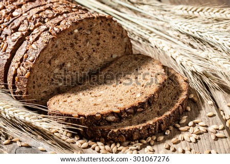 Sliced rye bread with seeds on a wooden table