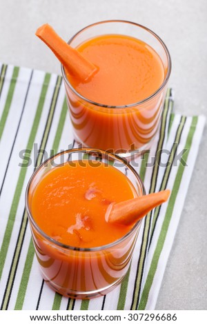 Glasses of natural carrot juice on the table