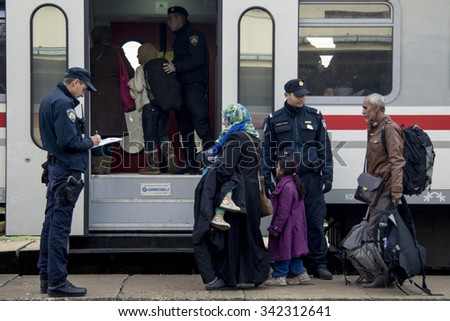 SID, SERBIA - NOVEMBER 14, 2015: Refugees boarding a train to the refugee camp of Slavonski Brod, in Croatia.