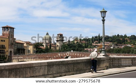 Old man walking by the river at Verona