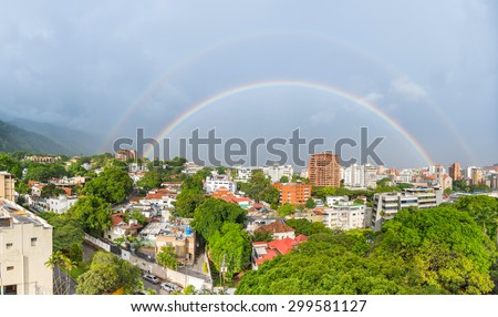 Spectacular full-circle double rainbow over Caracas city, capital of Venezuela
