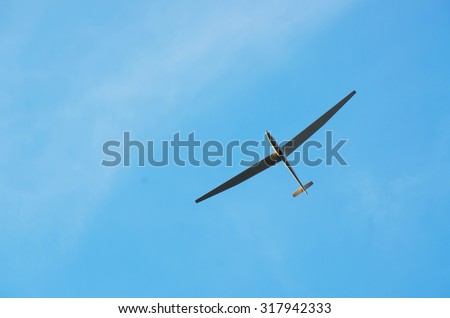 Glider in flight with a little veil clouds.