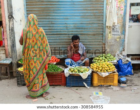 DELHI, INDIA - AUG 5, 2015. Unidentified man sells fruits from a stall in Delhi, India. Street vendors are widly spread through out the city.