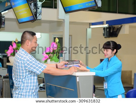 HO CHI MINH CITY, VIETNAM - JUL 2, 2015. A man checking-in at departure terminal in Tan Son Nhat International Airport. Tan Son Nhat is the largest airport located in southern Vietnam.