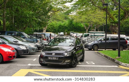 Singapore - Jun 22, 2015. Car parking lot at bus terminal in Singapore. The per-capita car ownership rate in Singapore is 12 cars per 100 people (or 1 car per 8.25 people).