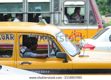 KOLKATA, INDIA -  AUG 2, 2015. Taxi driver in the car. The classical ambassador cab is the unique style of taxi service that imported from British civilization in Kolkata, India.