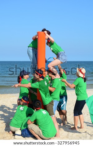 Vung Tau, Vietnam - June 29, 2015. Unidentified young people in the green uniform playing a team sport game on the beach in Vung Tau, southern Vietnam.