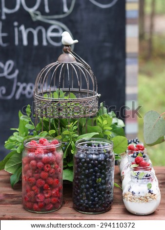 Wedding decorations, Berries in jars and bird cage with flowers