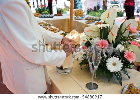 Waiter serving champagne on wedding buffet