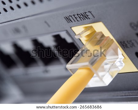 Network yellow cable connected to a router or modem