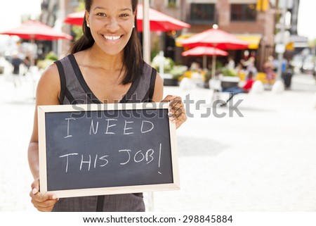 A young woman holding a chalkboard with the message \
