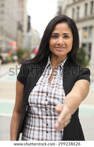 An attractive woman reaching out her hand to shake hands.