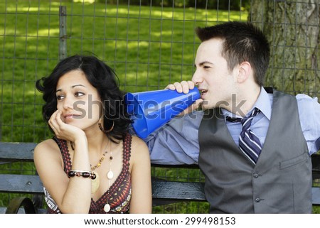 Woman ignoring man with megaphone.