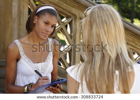 A woman interviewing another woman.