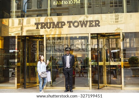 New York, New York, USA - May 30, 2012: A doorman stands at the entrance to Trump Tower on Fifth Avenue in New York City. People can be seen going in and out of the doors of this luxury residence.