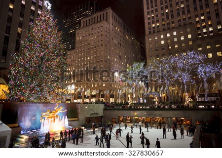 New York, New York, USA - December 10, 2012: The Rockefeller Center Christmas Tree shines brightly as people ice skate below on the famous Rockefeller Center rink in the evening.