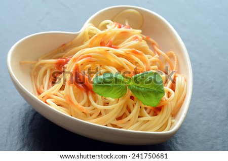 Spaghetti pasta in a heart shaped bowl