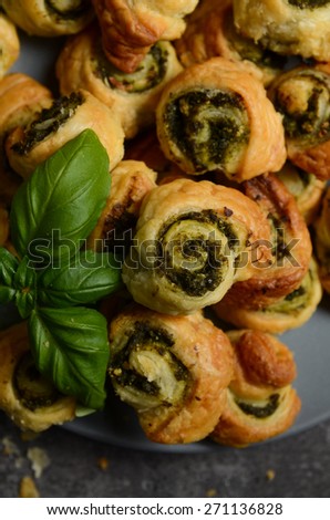 Puff pastry rolls with spinach and greek cheese filling on stone plate