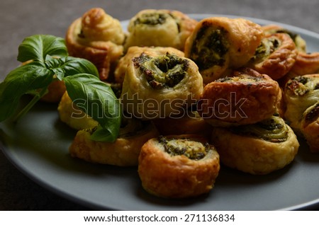 Puff pastry rolls with spinach and greek cheese filling on stone plate