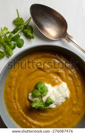 Bowl of fresh homemade sweet potato soup with ricotta cheese and coriander seasoning