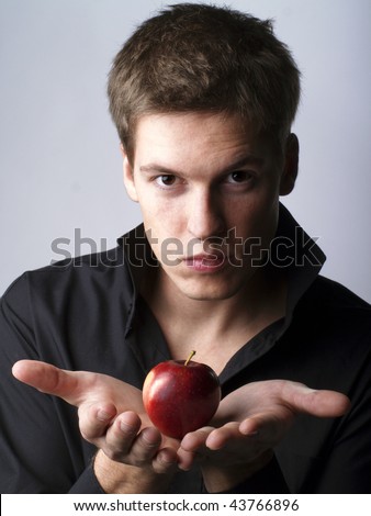 Handsome young male model holding an apple