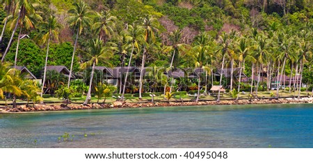 Bungalow house on the beach under palm tree, family rest, hotel and glass children place near sea water