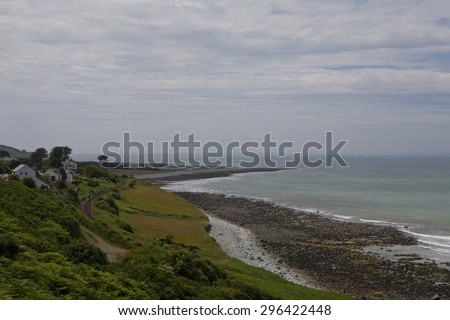 Llwyngwrill, United Kingdom - June 27, 2015: The coast line of Wales at Llwyngwrill is rocky and beautiful. A railway line follows the coast and houses look out over the Irish Sea.