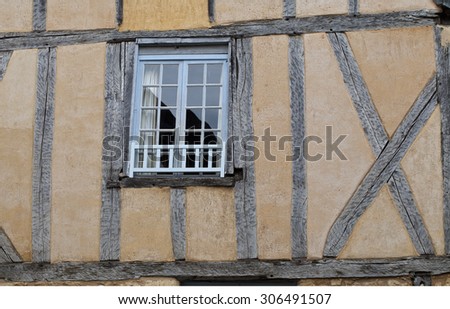 Old Window. A very old building with an out of line window found in an old historical market town in France.