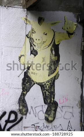 CIRCA MARCH 2014 - BERLIN: street art/ graffity in Berlin: pig in a punk outfit.